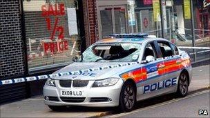 A damaged police car on Enfield High Street, north London