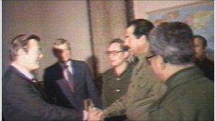Rumsfeld shakes hands with Hussein