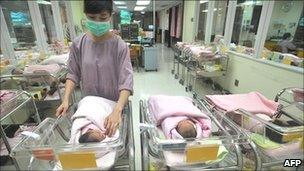 A nurse inspects newborn babies at a hospital in Taipei