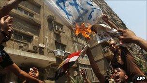 Egyptian demonstrators burn an Israeli flag during a protest outside the Israeli embassy in Cairo . Photo: 20 August 2010