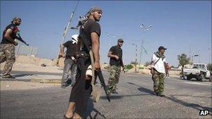Libyan rebel fighters seen at the checkpoint outside Zawiya, Libya, Saturday, Aug. 20, 2011