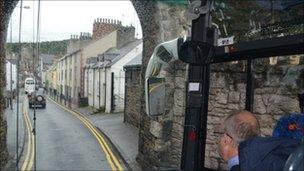 Coach driver approaching Conwy town wall archway