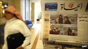 Man walks past newspaper stand in Saudi Arabia
