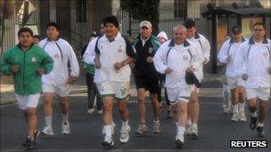 Bolivia's President Evo Morales (C) jogs surrounded by bodyguards on the newly implemented Pedestrian Day in La Paz September 4, 2011.