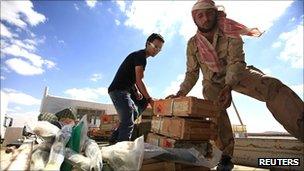 Rebel forces prepare crates of ammunition near Bani Walid