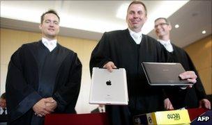 Samsung"s lawyers showing a Apple iPad computer tablet and a Samsung Galaxy Tab at the Duesseldorf courthouse