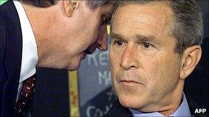 Andy Card whispers into President Bush's ear