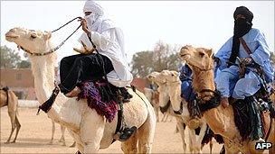 Tuareg men ride camels at the annual economic festival of Assihar