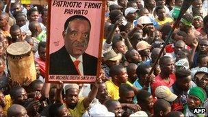 A Patriot Front supporter holds a portrait of the PF leader Michael Sata during a rally in the Zambian district of Mandevu in Lusaka on 15 September 2011