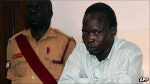 Thomas Kwoyelo (right) appears before the International Crimes Division court in the northern town of Gulu in July 2011