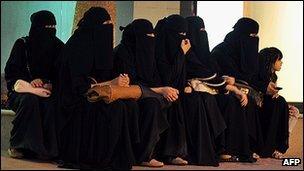 Saudi women wait for their drivers outside a shopping mall in Riyadh