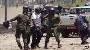 Paramilitary police clash with a bodyguard of opposition leader Cellou Dalein Diallo, after stopping Diallo's convoy on the way to a protest march in Conakry, Guinea, on 27 Sept