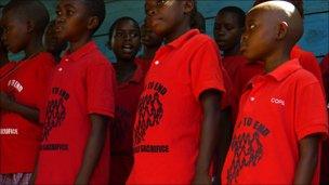 Children in Uganda wearing "Pray to end child sacrifice" t-shirts