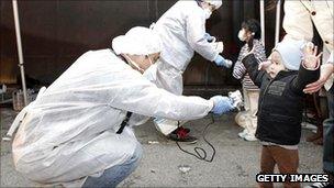 Officials in Japan check for signs of radiation on children