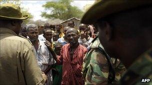 Kenyan security forces talk with residents at a village near near Liboi, Kenya's border town with Somalia on October 15