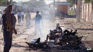 A Somali government soldiers secure the scene of a suicide attack that killed at least five people on 18 October 2011 in Mogadishu