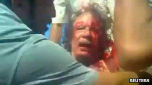 Still image from amateur video shot of Colonel Gaddafi after his capture in Sirte on 21 October 2011