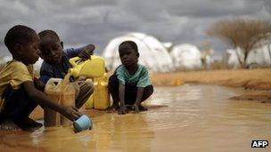 Somali boys fetching water from a puddle in Dadaab refugee camp in Kenya