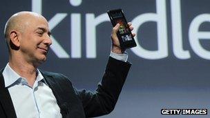 Amazon's chief executive, Jeff Bezos, holds up the Kindle Fire tablet