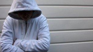 A teenager wearing a hooded top