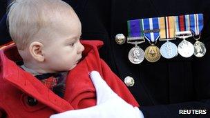 Murren Lawton held by father Royal Marine Corparal Shane Lawton, at a service in Fort William, Scotland