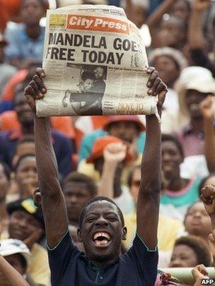Man holding newspaper on the day Nelson Mandela was set free