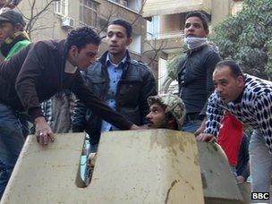 Egyptian protesters speak with army soldier on APC