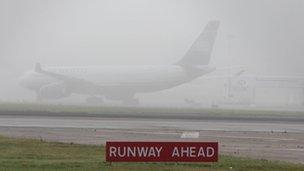Plane in thick fog at Heathrow Airport