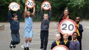 Children with 20mph signs