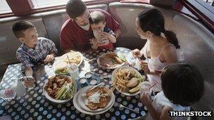 Family eating in a diner booth