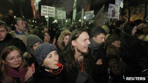 Participants blow whistles and shout during an opposition protest in central Moscow on 5 December 2011