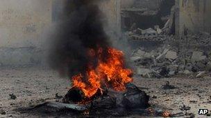 A car burns shortly after it exploded in Mogadishu