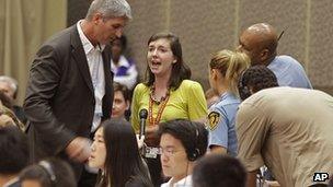 US protester Abigail Borah disrupts negotiator Todd Stern in Durban, South Africa on 8 December 2011