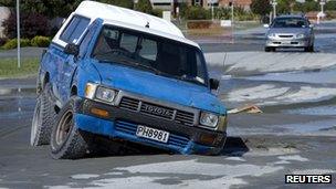 Vehicle trapped in pothole caused by liquefaction