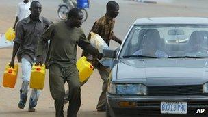 Nigerians try to sell fuel on the black market during a strike in 2004