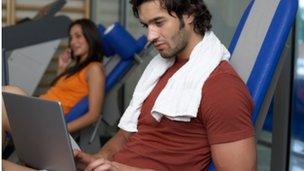 Man at the gym on a laptop