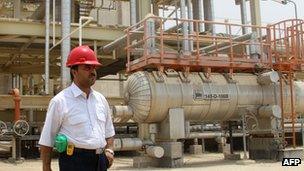 An Iranian worker stands in front of the South Pars gas field