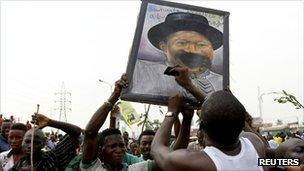 Protesters deface a portrait of Nigeria's President Goodluck Jonathan during a protest against fuel subsidy removal in Lagos, 9 January, 2012