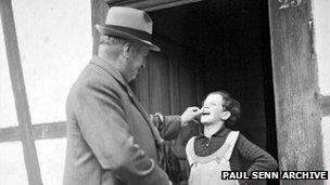 The 'poverty inspector' examines a contract girl's teeth (Paul Senn Archive, Bern)