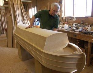 George Spencer of Crazy Coffins works on a boat-shaped casket