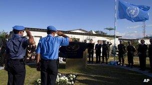 UN peacekeepers salute during a memorial service for people who died in the 2010 earthquake at the UN base in Port-au-Prince, Haiti, on 12 January 2012