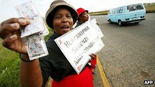 Women from the mining community pass out condoms and educational leaflets on 2 April 2004 in the Witbank District in the Gauteng Province of South Africa.