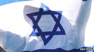 A child holds an Israeli flag during a tennis match