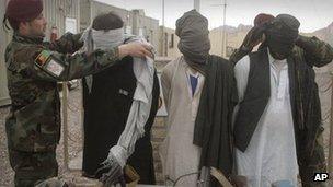 Afghan soldiers display detained Taliban militants to the news media in Herat, west of Kabul, Afghanistan, on 29 January 2012