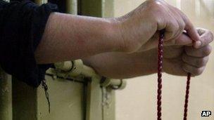 An Iraqi inmate with prayer beads at Baghdad's prison. File photo