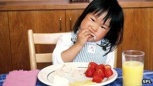 Child eating strawberries