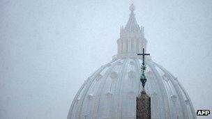 Snow falling over St Peter's Basilica at the Vatican on 3 February 2012
