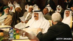 Qatar's Emir Sheikh Hamad bin Khalifa al-Thani laughs with Palestinian leader Mahmud ABbas