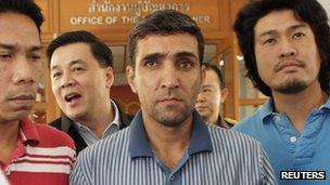 Police parade suspect Mohammad Khazaei at the immigration bureau