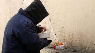 A Greek man eats food distributed by the Athens Municipality